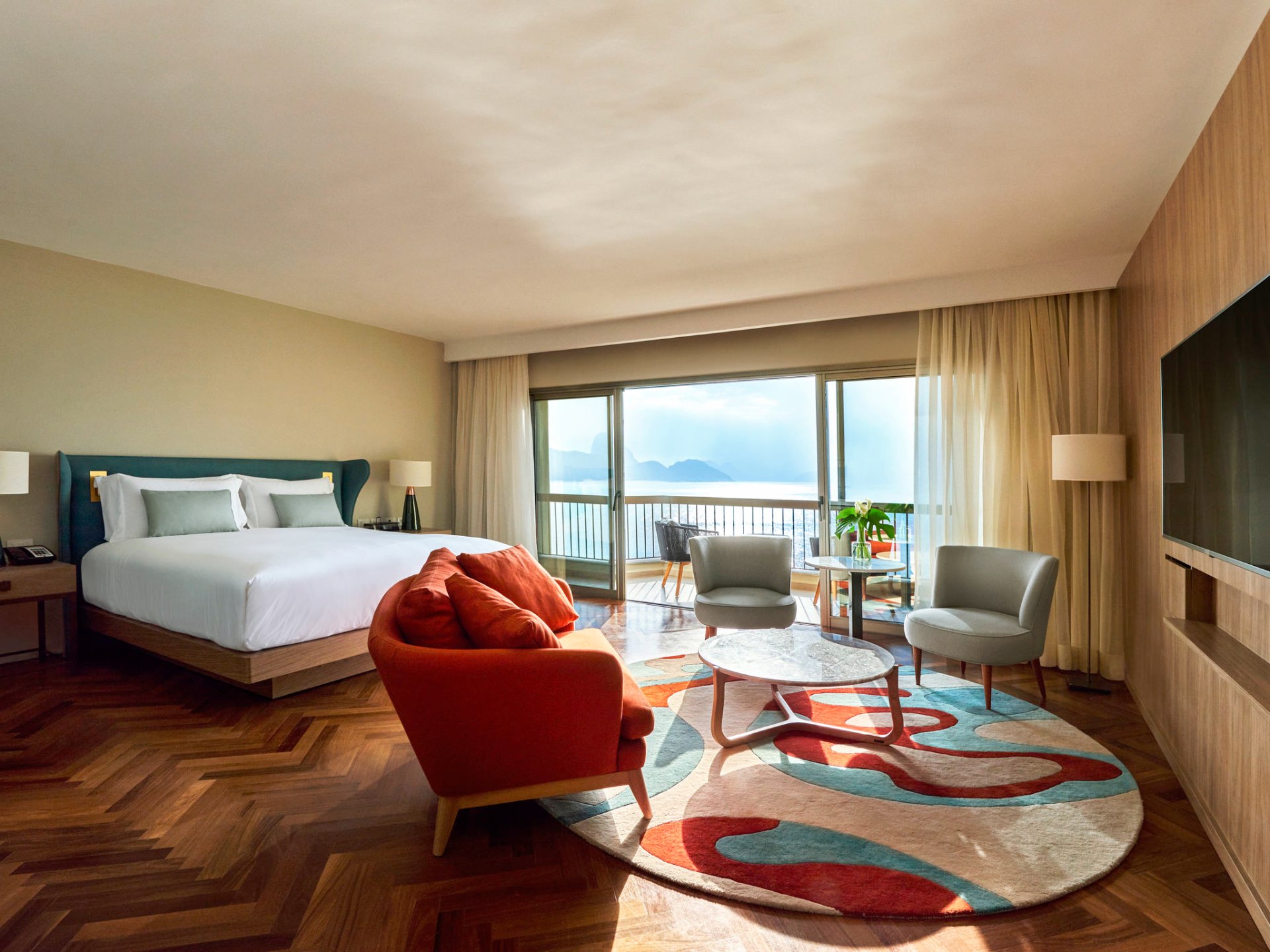 Fairmont Copacabana suite with king bed and balcony view of the bay