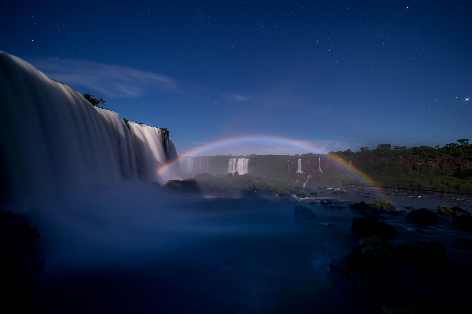 Full moon rainbow over Iguazu Falls at night from Belmond